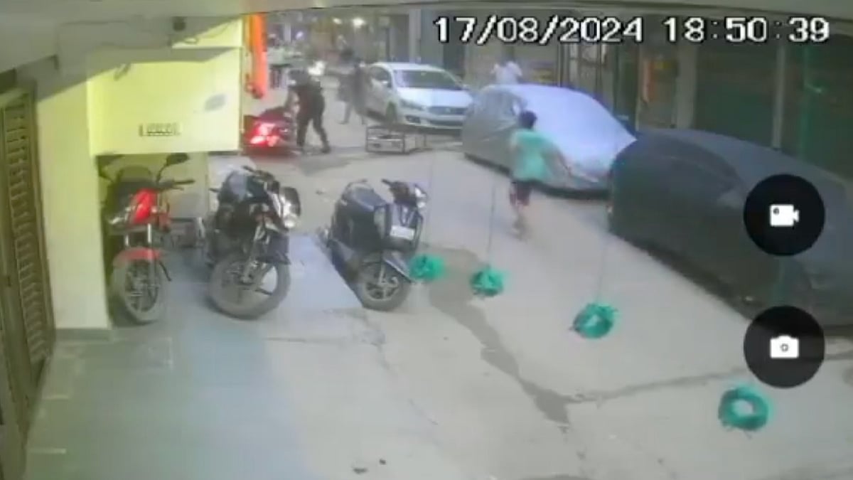 CCTV footage screengrab via X : Teenager dies after AC outdoor unit falls on him in Delhi |
